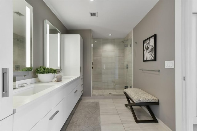 full bathroom with a shower stall, double vanity, recessed lighting, and baseboards