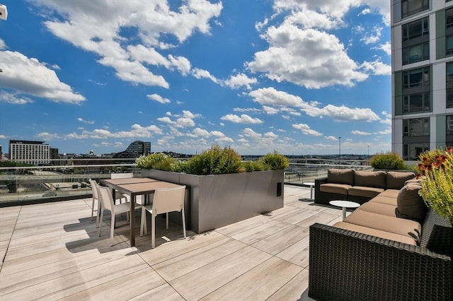 wooden terrace featuring an outdoor living space and outdoor dining area