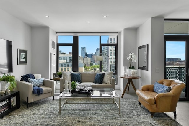 living area with a view of skyline, floor to ceiling windows, and recessed lighting