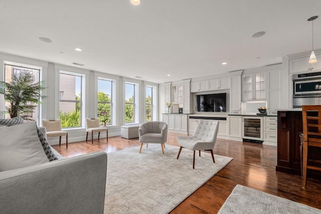 living area featuring wine cooler, visible vents, dark wood-style flooring, and recessed lighting