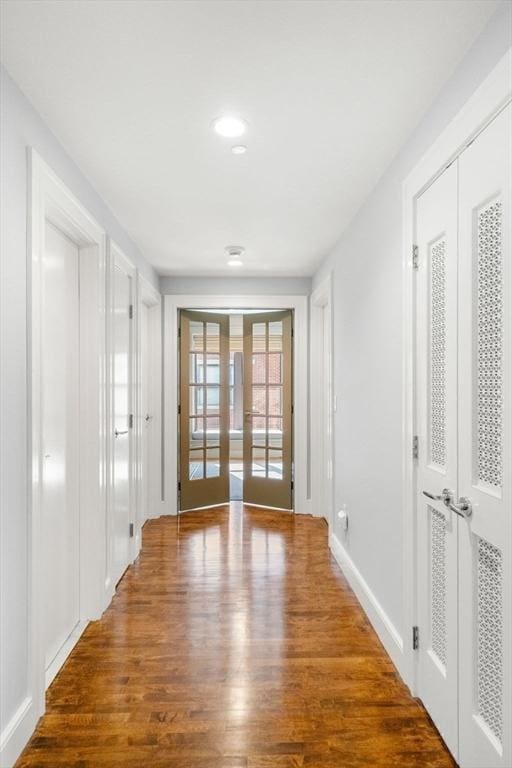 spare room featuring recessed lighting, french doors, baseboards, and wood finished floors