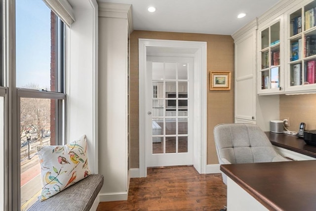 office featuring a healthy amount of sunlight, baseboards, and dark wood finished floors