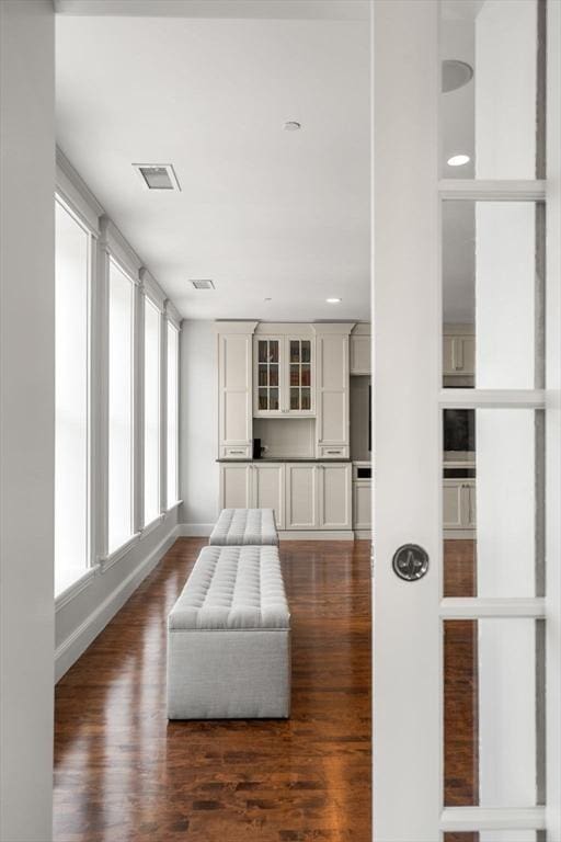 unfurnished room featuring visible vents and dark wood-type flooring