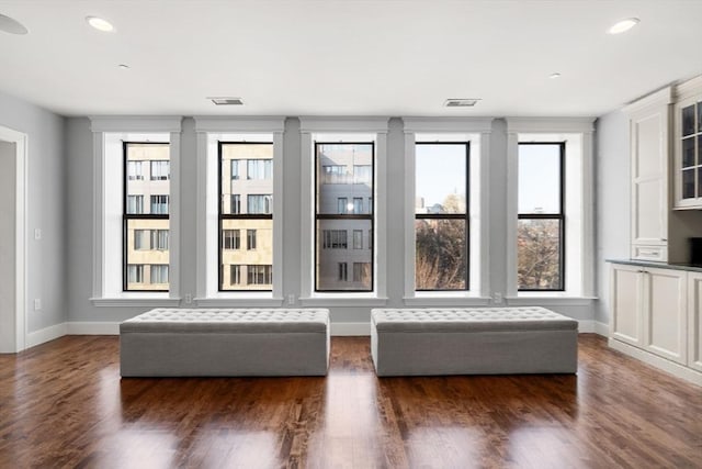 interior space featuring recessed lighting, visible vents, baseboards, and wood finished floors