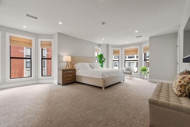 carpeted bedroom with access to exterior, baseboards, visible vents, and recessed lighting