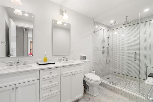 full bath featuring a stall shower, a sink, toilet, and double vanity