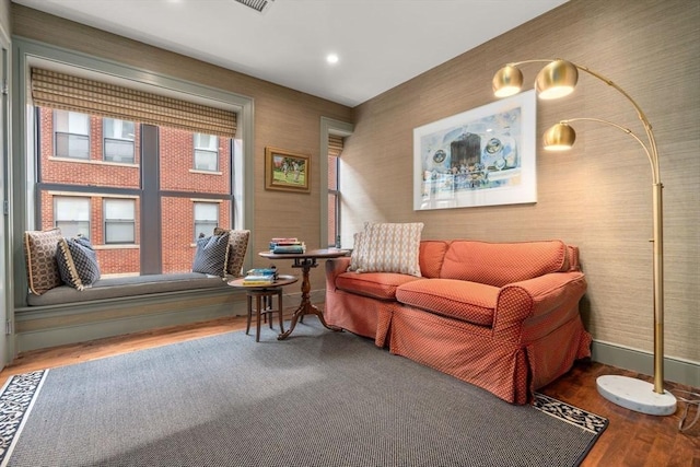 living area with wallpapered walls, baseboards, wood finished floors, and recessed lighting