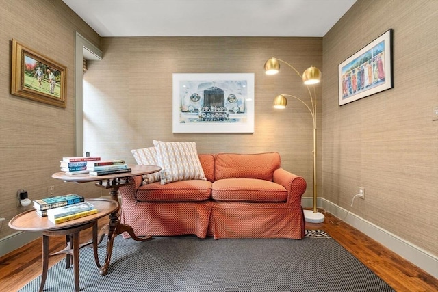 living area featuring baseboards and wood finished floors