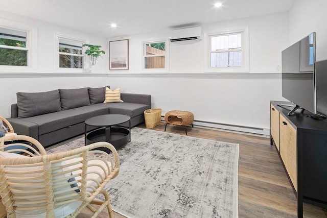 living room featuring recessed lighting, an AC wall unit, baseboard heating, and wood finished floors