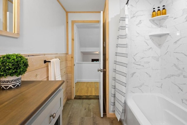 full bathroom featuring shower / tub combo with curtain, wood finished floors, and vanity