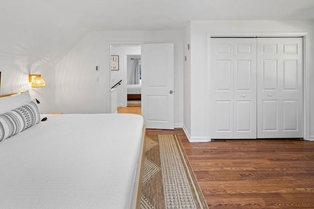 bedroom featuring a closet, baseboards, and wood finished floors