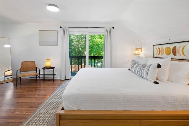 bedroom featuring baseboard heating, baseboards, access to outside, vaulted ceiling, and wood finished floors
