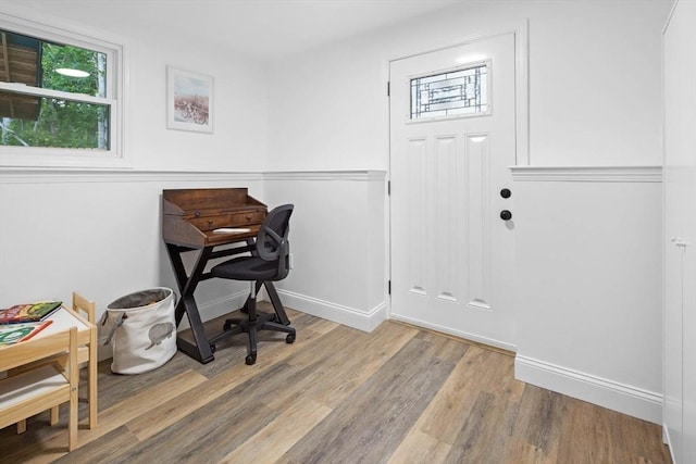office space with baseboards and wood finished floors
