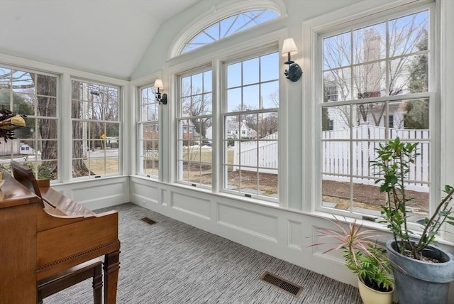 sunroom featuring visible vents and vaulted ceiling