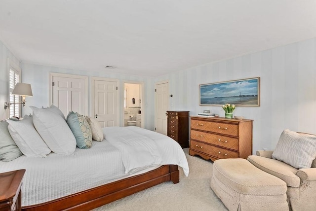 bedroom featuring carpet floors and ensuite bathroom