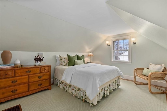 bedroom with baseboards, vaulted ceiling, and carpet flooring