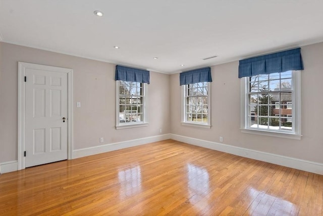 spare room featuring visible vents, recessed lighting, light wood-style flooring, and baseboards