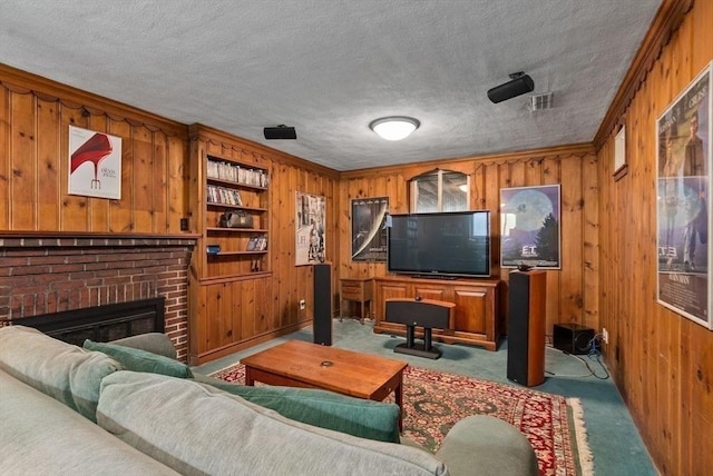 living area featuring a textured ceiling, wood walls, a brick fireplace, and carpet flooring