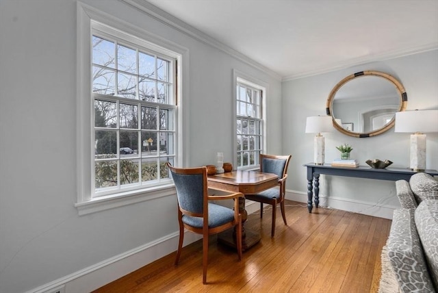 dining space with plenty of natural light, wood-type flooring, and baseboards