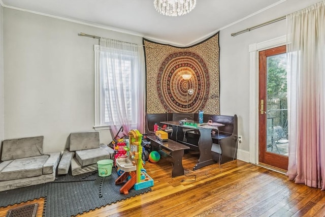 114 Chancery St, New Bedford, MA 02740 - recreation room featuring ornamental molding, wood-type flooring, healthy amount of natural light, a chandelier, and baseboards