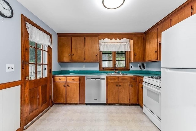 70 Fox Meadow Ln, Dedham, MA 02026 - kitchen with white appliances, brown cabinets, light countertops, and light flooring
