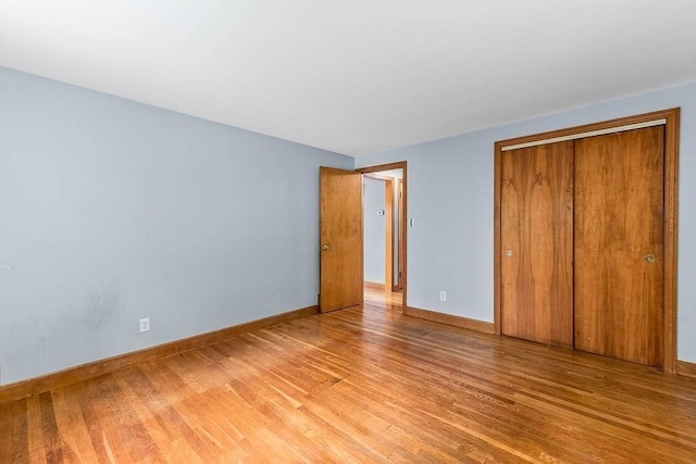 70 Fox Meadow Ln, Dedham, MA 02026 - unfurnished bedroom featuring light wood-style floors and a closet