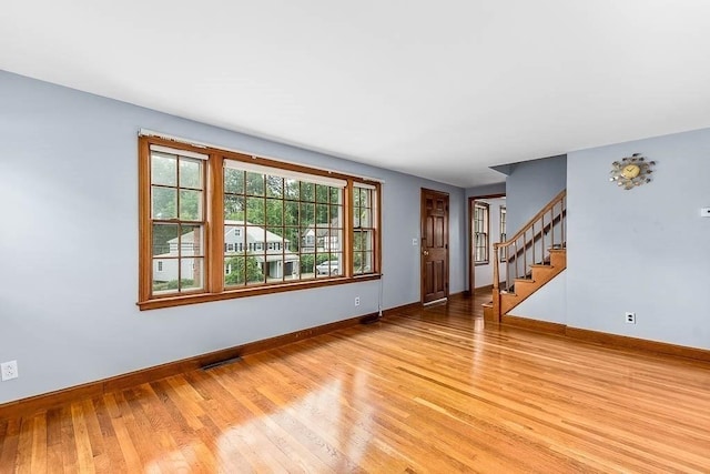 70 Fox Meadow Ln, Dedham, MA 02026 - unfurnished living room featuring light wood-style floors and stairs