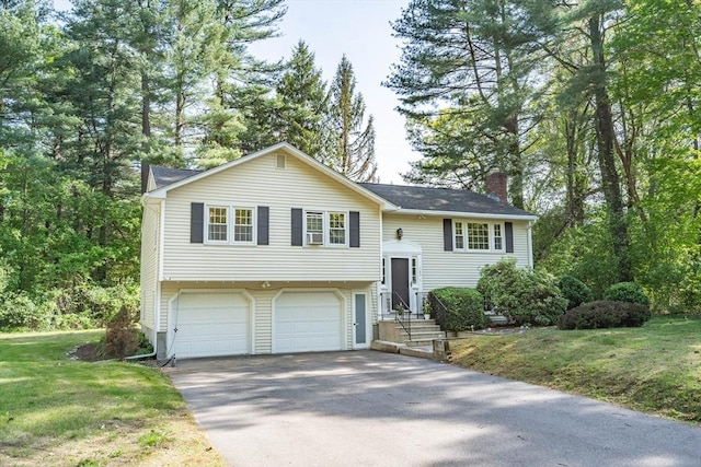 143 Davis St, Northborough, MA 01532 - split foyer home with asphalt driveway, a chimney, a garage, and a front yard