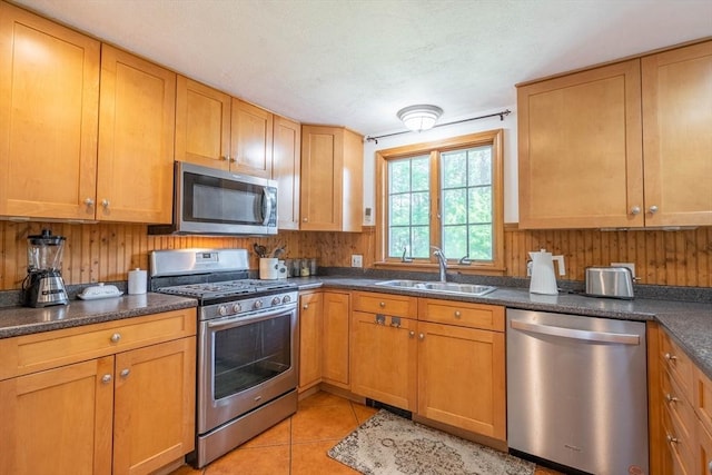 143 Davis St, Northborough, MA 01532 - kitchen featuring appliances with stainless steel finishes, a sink, dark countertops, and light tile patterned floors