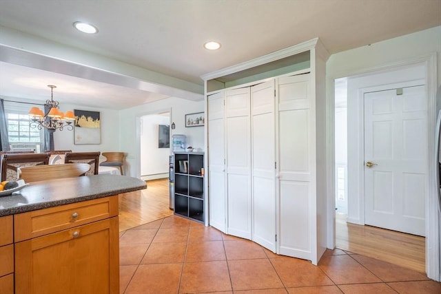 143 Davis St, Northborough, MA 01532 - kitchen with light tile patterned floors, a chandelier, dark countertops, pendant lighting, and recessed lighting