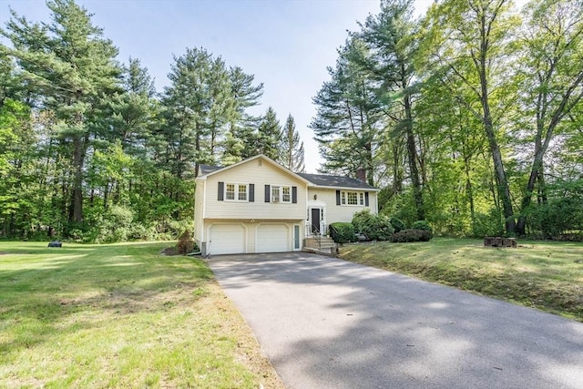 143 Davis St, Northborough, MA 01532 - raised ranch featuring a garage, a chimney, asphalt driveway, and a front lawn