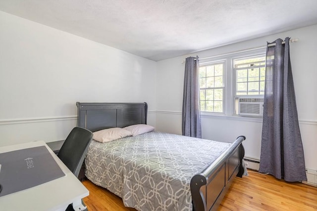 143 Davis St, Northborough, MA 01532 - bedroom with a baseboard heating unit and light wood-style flooring