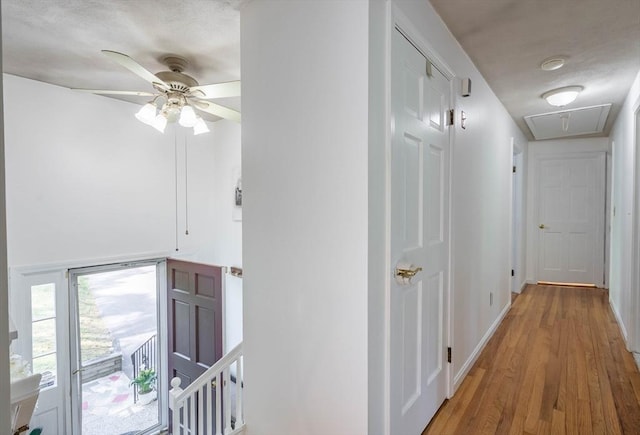 143 Davis St, Northborough, MA 01532 - corridor featuring attic access, an upstairs landing, wood finished floors, and baseboards