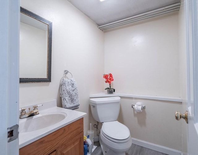 143 Davis St, Northborough, MA 01532 - bathroom with toilet, vanity, wood finished floors, and baseboards