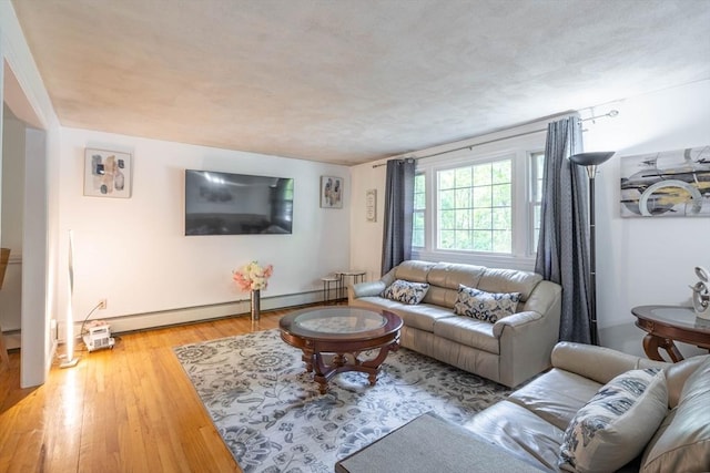 143 Davis St, Northborough, MA 01532 - living area featuring wood finished floors, a baseboard radiator, and baseboards