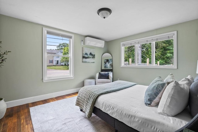 213 Thurston St, Wrentham, MA 02093 - bedroom featuring multiple windows, baseboards, an AC wall unit, and wood finished floors