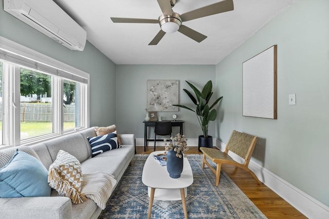 213 Thurston St, Wrentham, MA 02093 - living area with a wall unit AC, wood finished floors, a ceiling fan, and baseboards