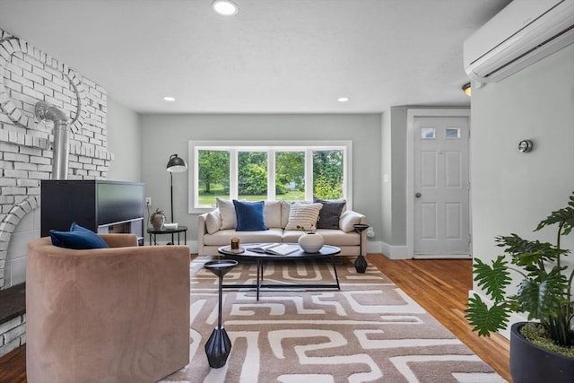 213 Thurston St, Wrentham, MA 02093 - living room featuring a wall mounted AC, wood finished floors, a wood stove, recessed lighting, and baseboards