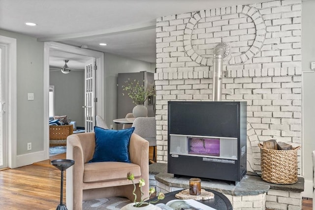 213 Thurston St, Wrentham, MA 02093 - living area featuring wood finished floors, recessed lighting, ceiling fan, baseboards, and a wood stove