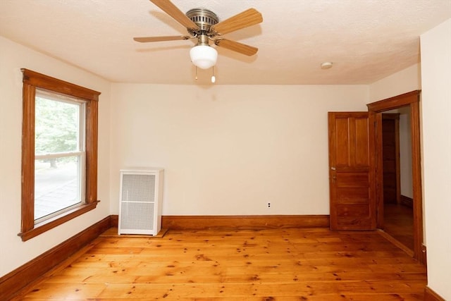 spare room featuring light wood-type flooring and ceiling fan