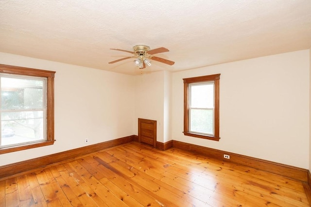 empty room featuring ceiling fan and hardwood / wood-style flooring