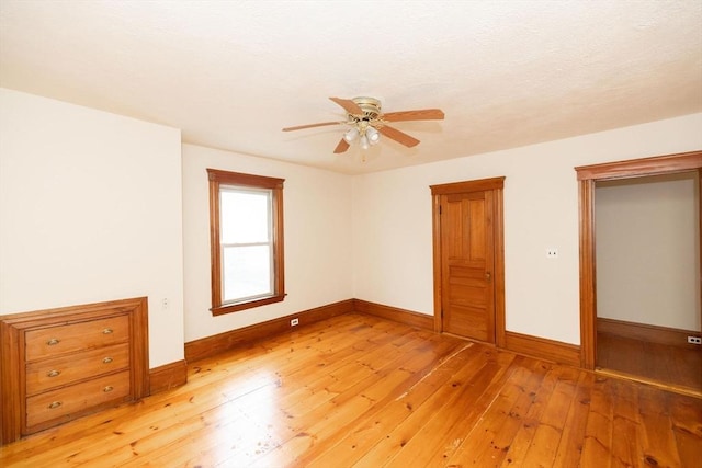 unfurnished bedroom with ceiling fan and light wood-type flooring