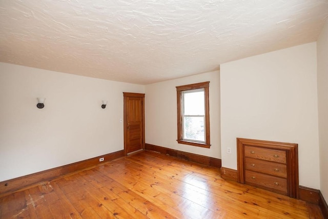 spare room with light hardwood / wood-style flooring