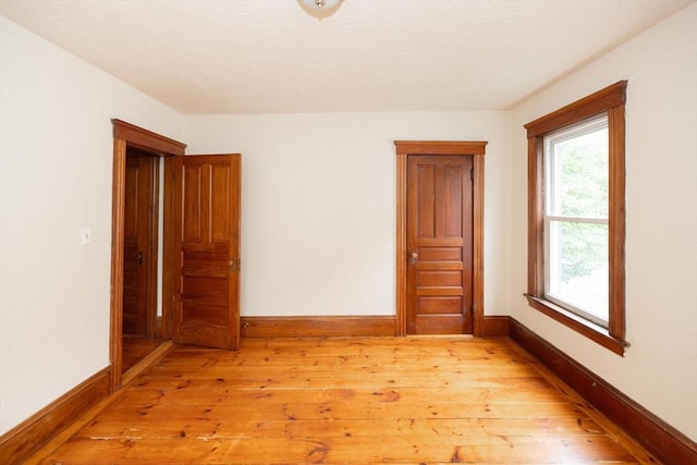 empty room with light hardwood / wood-style floors