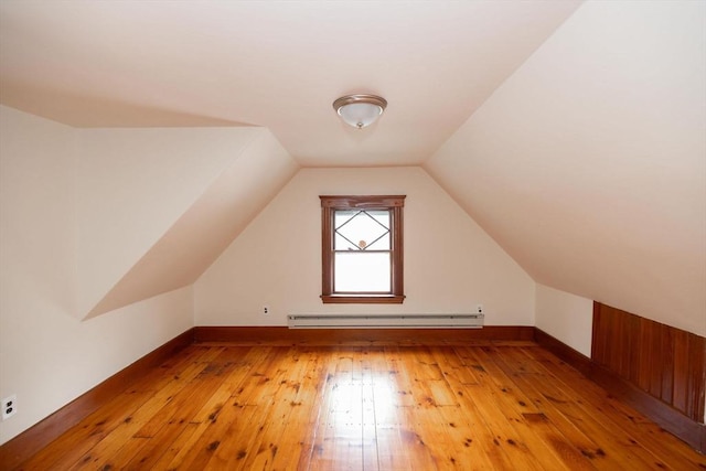 bonus room with light hardwood / wood-style floors, lofted ceiling, and baseboard heating