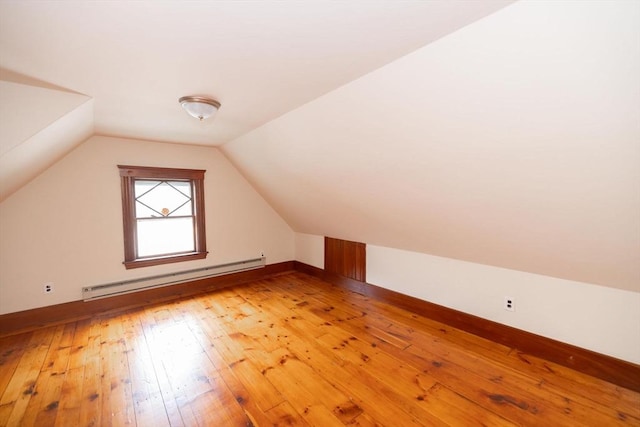 bonus room featuring a baseboard radiator, lofted ceiling, and wood-type flooring