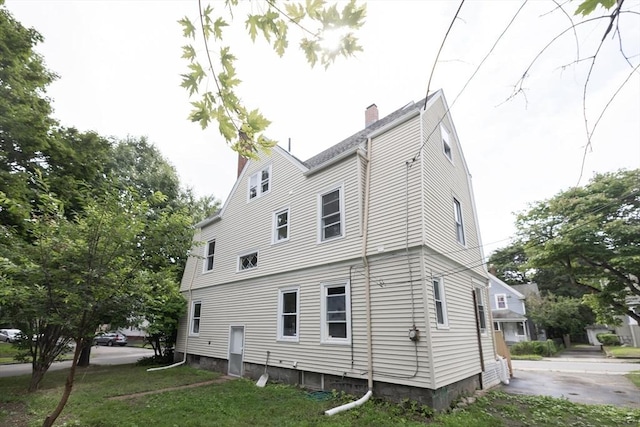 back of property featuring a yard