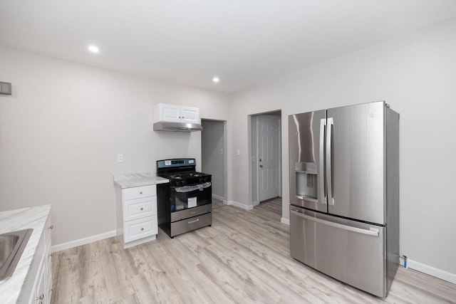 kitchen featuring sink, white cabinets, light hardwood / wood-style floors, and appliances with stainless steel finishes