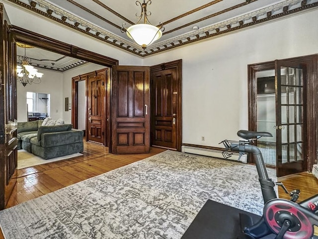 interior space featuring french doors, ornamental molding, a notable chandelier, and light hardwood / wood-style flooring