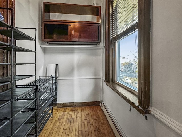 interior space featuring a baseboard radiator and hardwood / wood-style flooring